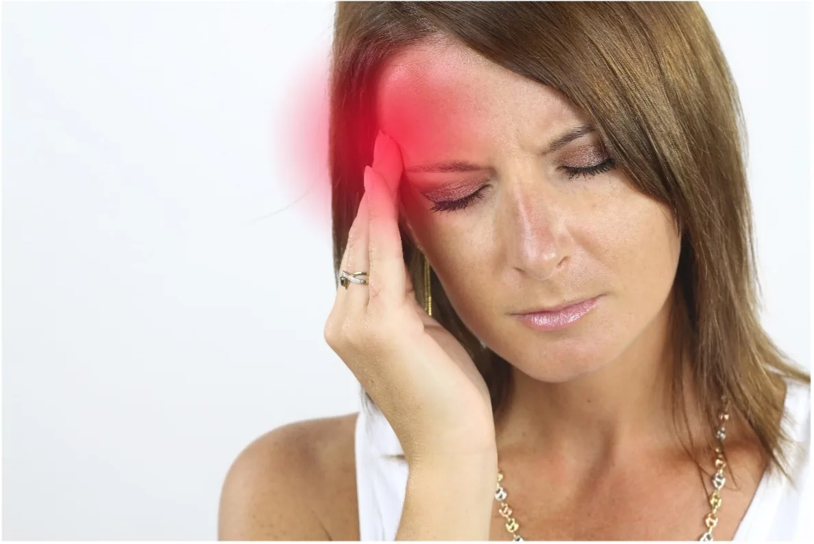 A woman holding her head during a migraine attack