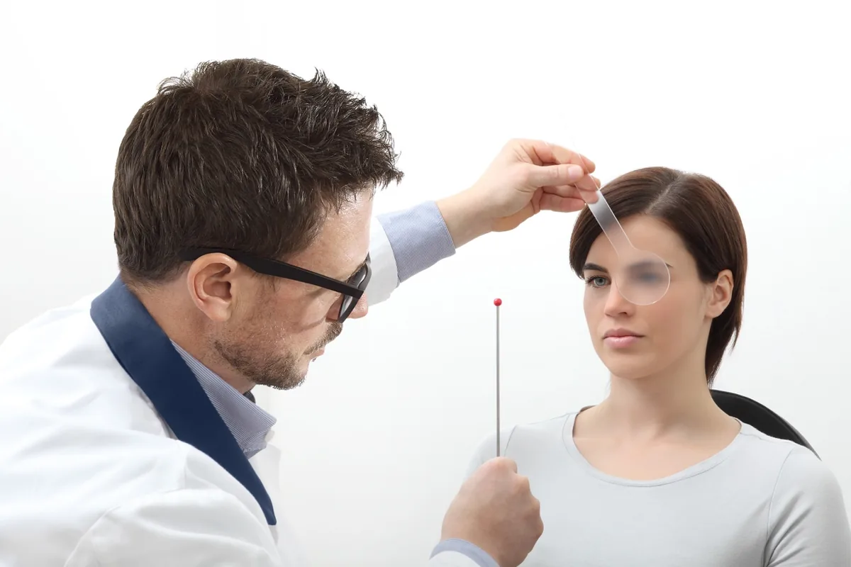 An orthoptist testing a child's eye alignment